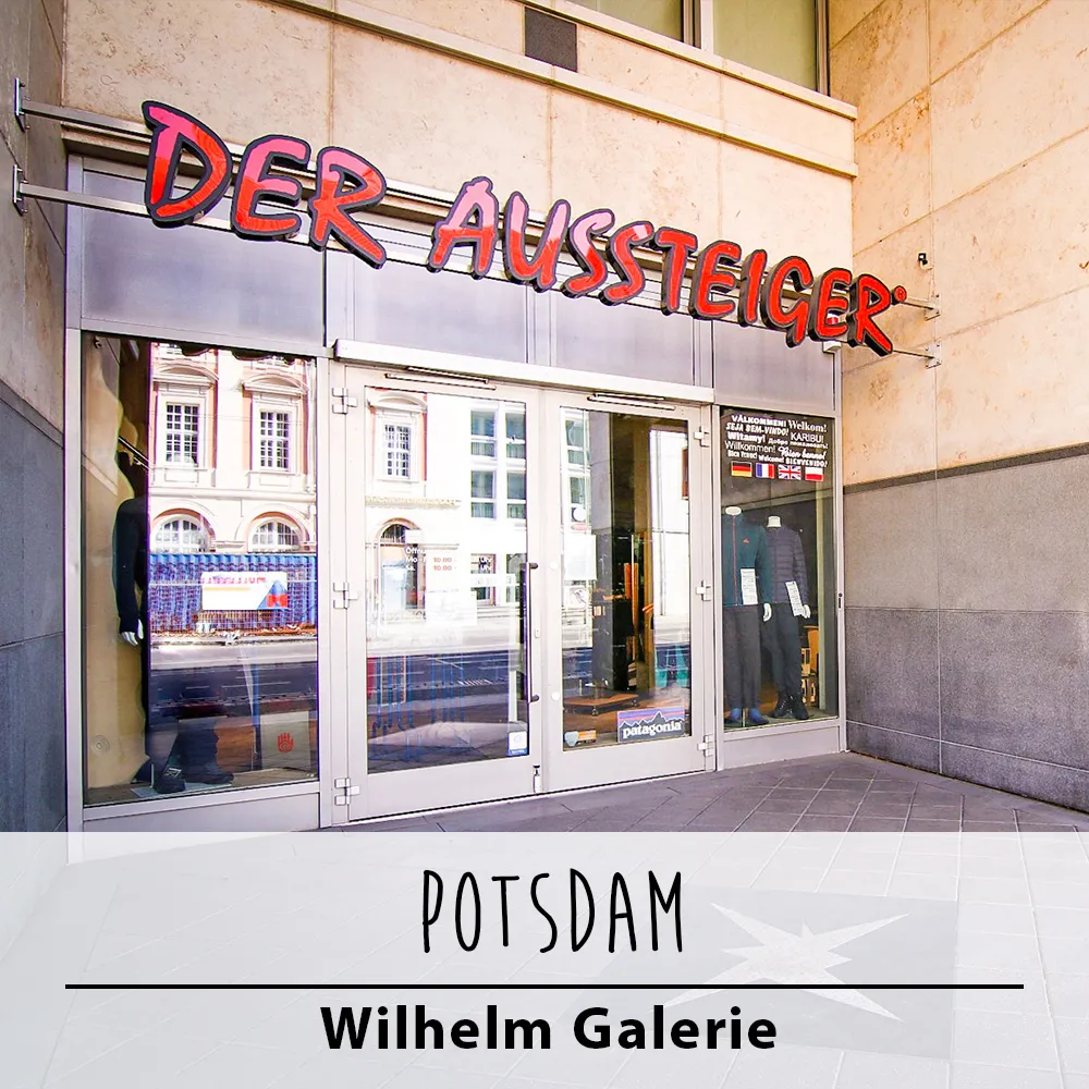 Die Fassade eines Geschäfts mit großen Glastüren und einem Schild mit der Aufschrift „DER AUSSTEIGER“.