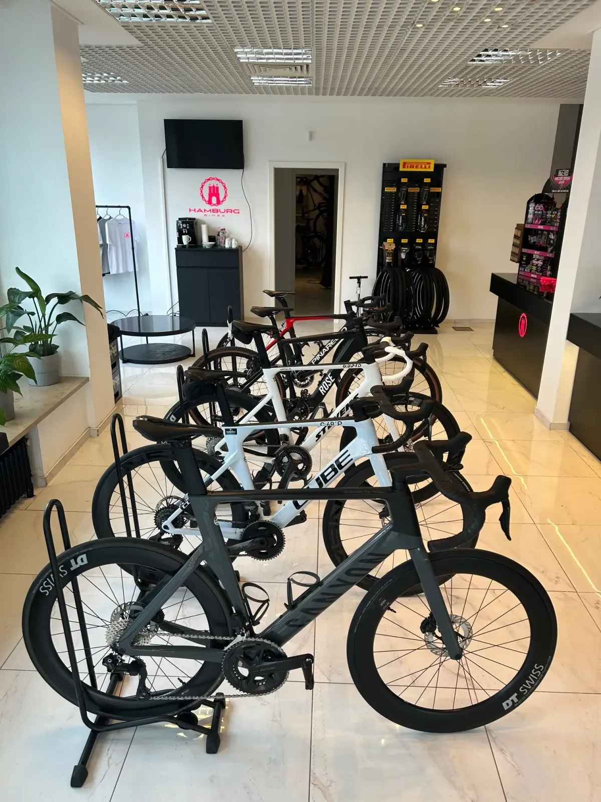 Several road bikes are displayed in a showroom.